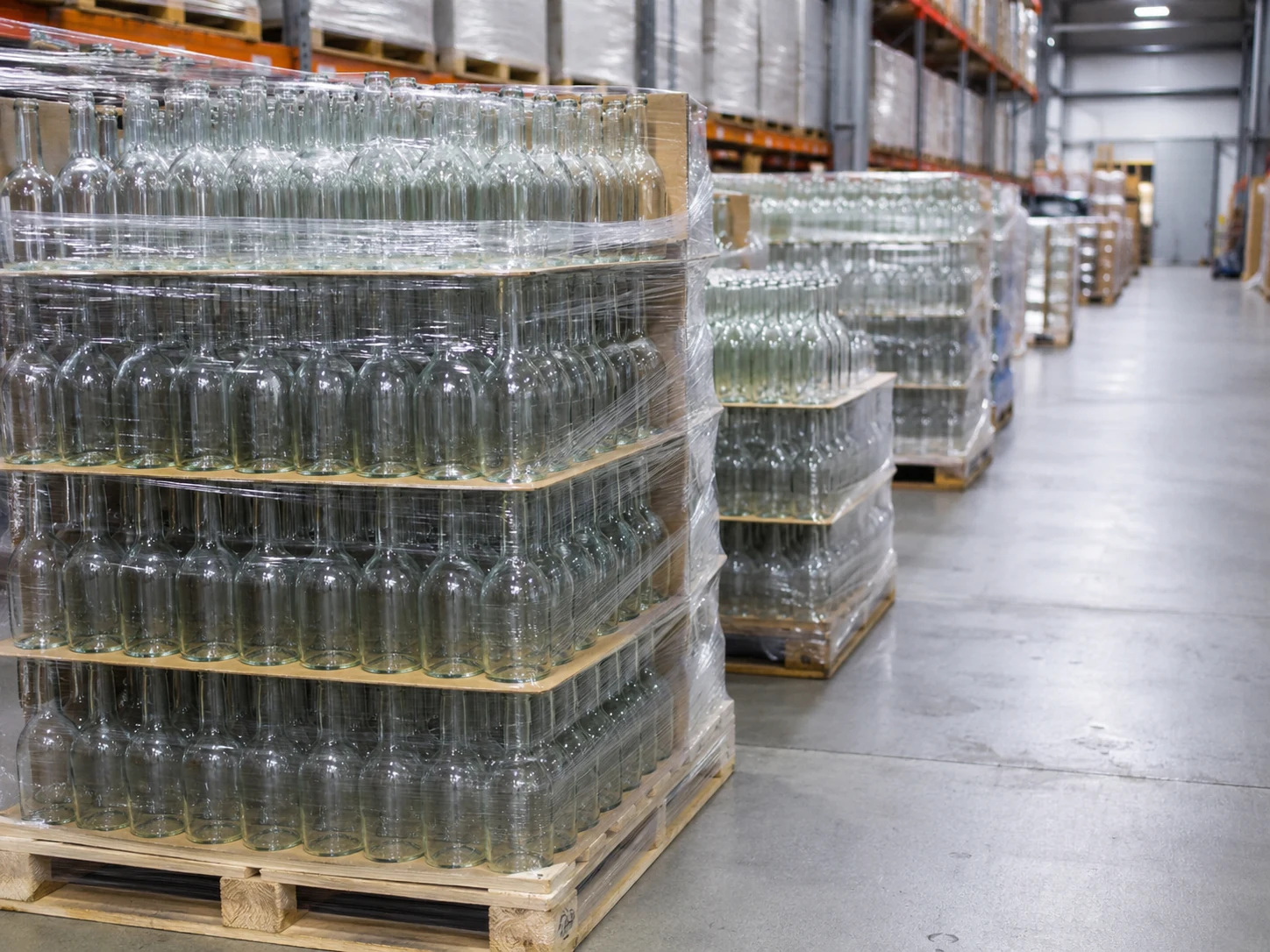 Homepage Palletised cases of bottled beverages in a distribution warehouse