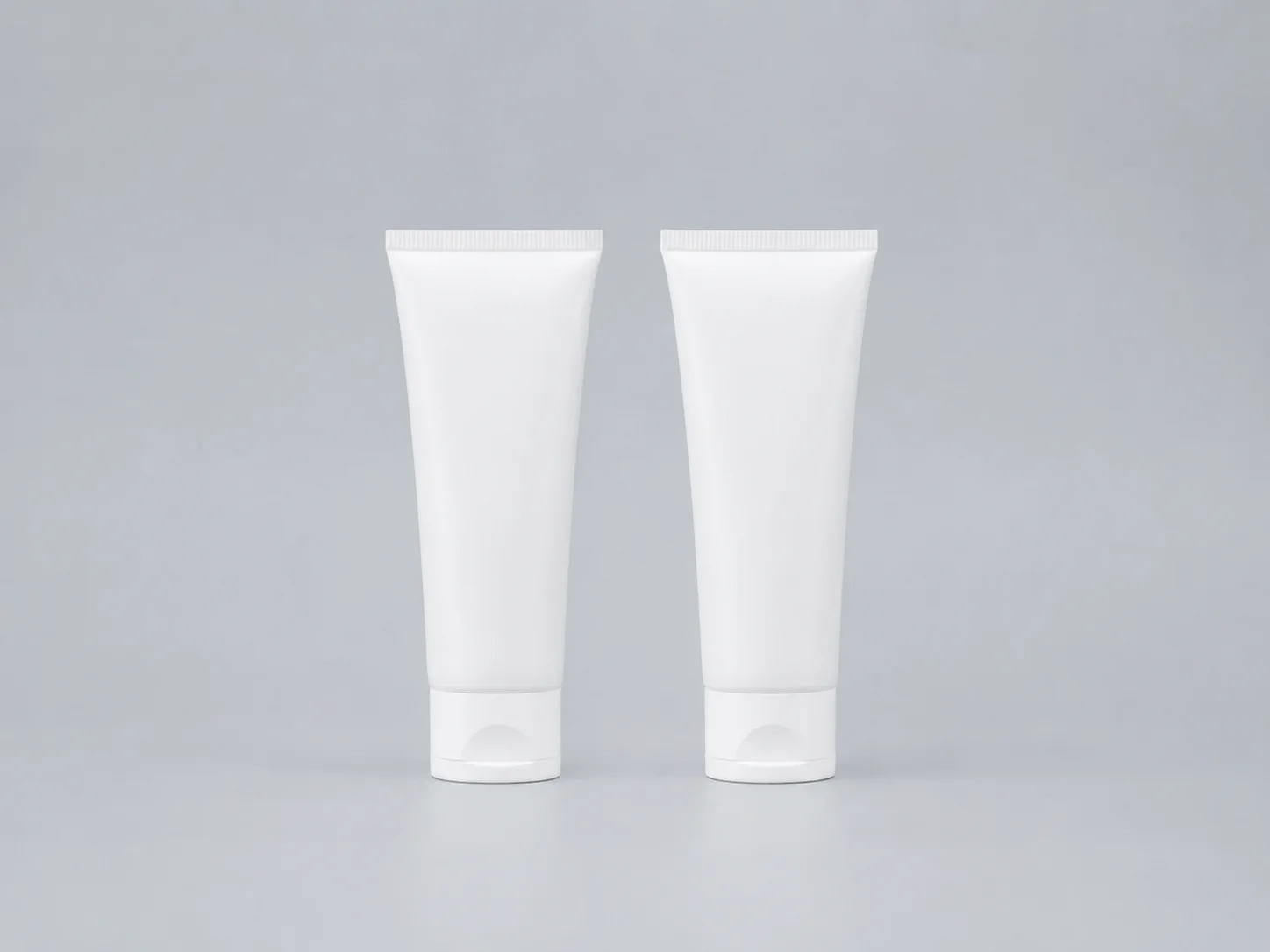 Two visually identical unlabelled tubes side by side on a clean surface